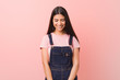 © Asier - Young pretty arab woman wearing a jeans dungaree laughs and closes eyes, feels relaxed and happy.