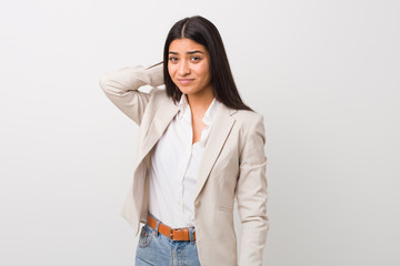 Young business arab woman isolated against a white background touching back of head, thinking and making a choice.