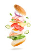 © virtustudio - Sandwich with flying ingredients isolated on a white background. Layered delicious bagel, ham, cheese and fresh vegetables