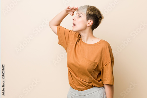 Young Plus Size Woman With Short Hair Looking Far Away Keeping