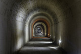 Fototapeta  - A dark, deserted underground tunnel