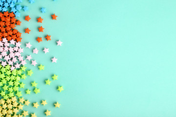 Wall Mural - Colorful paper stars on blue background