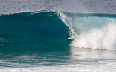 Wall Mural - A Surfer riding in a barrel wave