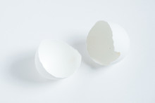 An Empty Broken Egg Shell On A White Background.