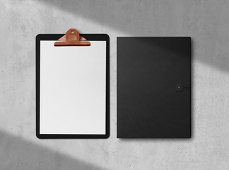 Mock-up. Clipboard with sheets of paper, business cards and folder on concrete background. Template for branding identity. Blank objects for placing your design. 3d illustration.