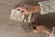 © Vergani Fotografia - Banknotes of Canadian currency: Dollar. Overhead of senior person holding bills.