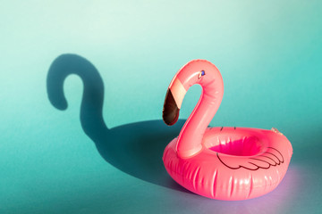 Giant inflatable Flamingo on a blue background, pool float party, trendy summer concept