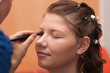 © patrikslezak - Close up face of young bride, artist doing make up. Bride has scar on eybrow after piercing.