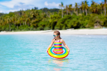 Wall Mural - Child on tropical beach. Sea vacation with kids.