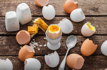 Healthy breakfast with soft boiled egg and empty shells, rustic style