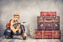 Retro Teddy Bear Toy In Tourist Hat Sitting On Old Rusty Children's Pedal Scooter From 60s, Leather Backpack And Outdated Trunks Luggage, Antique Valises. Travel Concept. Vintage Style Filtered Photo