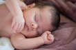 © javgutierrez - closeup of beautiful newborn baby asleep on a violet blanket