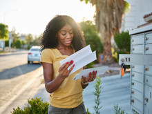 African American Woman Checking Mail In Las Vegas Community
