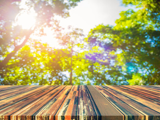 wood table and image of green  bokeh.