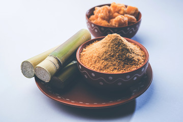 Sticker - Organic Gur or Jggery Powder is unrefined sugar obtained from concentrated sugarcane juice. served in a bowl. selective focus