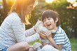© lalalululala - Asian mother and her son playing with cat