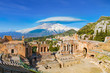 Ancient Greek theatre in Taormina on background of Etna Volcano, Italy