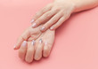 © Egor - Tender hands with perfect nude manicure on trendy pastel pink background. concept of healthy and beautiful hands.