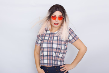 Blonde woman wearing sunglasses over white background