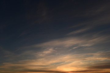 Wall Mural - Blue sky in white  cirrus cloud  in the patterns of sunset light and shadows