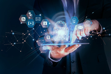 business man secures network data personal information on tablet, data protection privacy concept, s