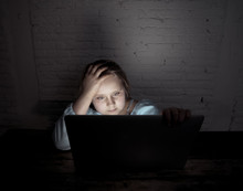 Sad Young Girl With Laptop Suffering Bullying And Harassment Online. Cyber Bullying Victim
