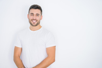 Young handsome man smiling happy wearing casual white t-shirt over white isolated background