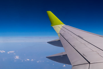 Aerial view from plane window with airplane wing