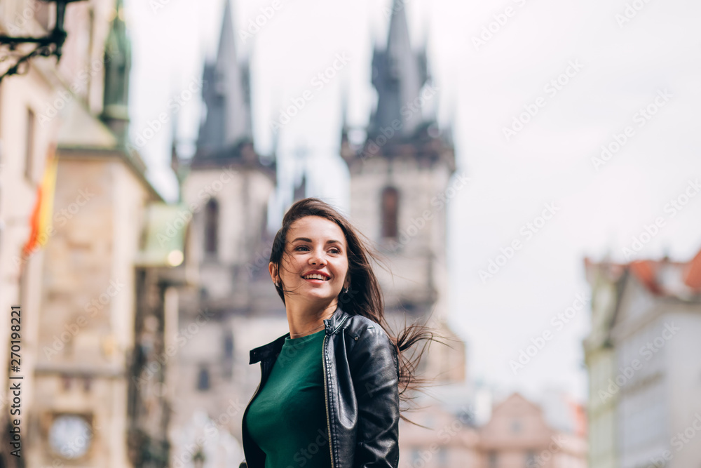 Street portrait of adorable brunette woman with long hair posing at Old ...