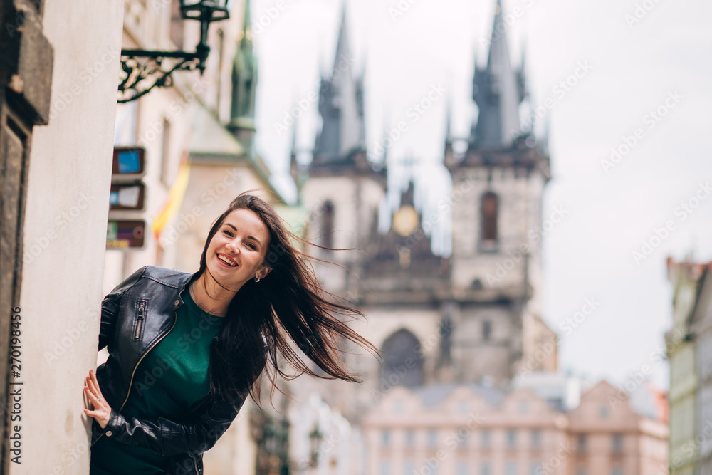 Street portrait of adorable brunette woman with long hair posing at Old ...