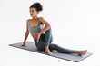 © Drobot Dean - Amazing stronger sports fitness african woman make exercises isolated over white wall background.