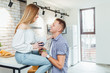 © Тарас Нагирняк - Romantic young couple drinking coffee together in the kitchen,having a great time together. Family day.