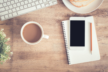 Wall Mural - top view of office table . on desk have notebook coffee cup laptop smartphone and pencil.
