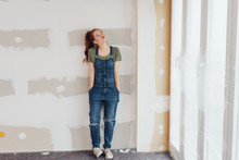 Cute Young Woman In Denim Dungarees