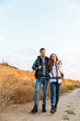© Drobot Dean - Happy young loving couple outside with backpack in free alternative vacation camping.