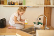 © Yakobchuk Olena - Adorable little girl washing dishes at home
