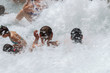 © jefwod - Saturnia, Italy. 04-28-2019. People bathing in natural spa of the hot Mill waterfalls of  cascate dele Mulino. Grosseto, Tuscany, Italy