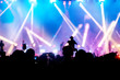 © miraclebuggy - Silhouette image and Defocus of entertainment concert colorful lighting on stage,Audience taking photos of artist,blurred Live Concert and disco party.