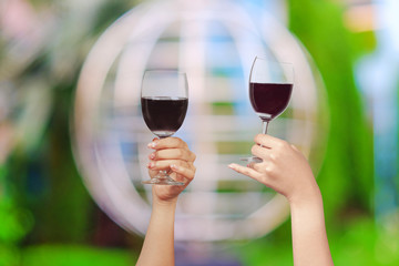 Hand hold wine glass for celebration on nature background.