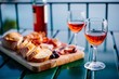 © nblxer - Two glasses of wine and italian snacks  with amazing view at sunset in Italy.