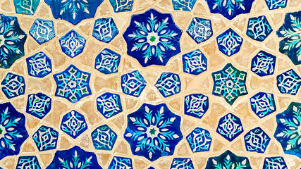 traditional Uzbek pattern on the ceramic tile on the wall of the mosque, background