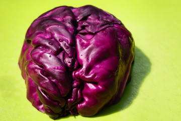Wall Mural - Close-up of red cabbage on green platic cutting board. Bright healthy vegan food