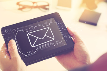 Email with man holding a tablet computer