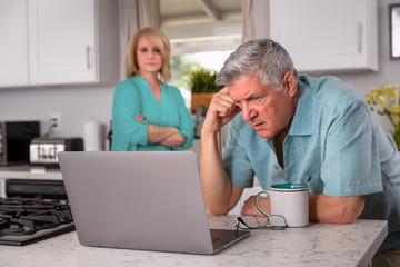 Poster - Senior couple stressed from receiving bad news in email, possibly health care, retirement funds, mortgage, or investments