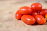 Fototapeta Kuchnia - Fresh cherry tomatoes on wooden background