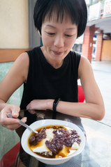 Canvas Print - smile Asian woman eat tofu pudding