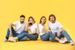 © Pixel-Shot - Stylish young people in jeans on color background