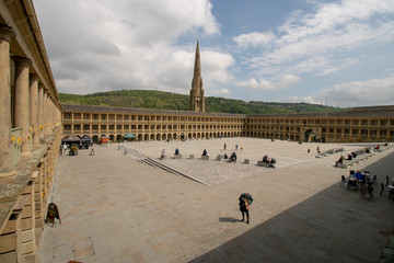 Halifax West Yorkshire UK, 10th May 2019: Photo of the famous Piece Hall in the Blackledge area of Halifax, showing the historic stone build building, taken on a part cloudy sunny day.