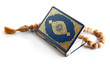 Muslim beads and Koran on white background