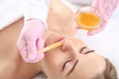 © Pixel-Shot - Beautician removing hair above upper lip of young woman in salon